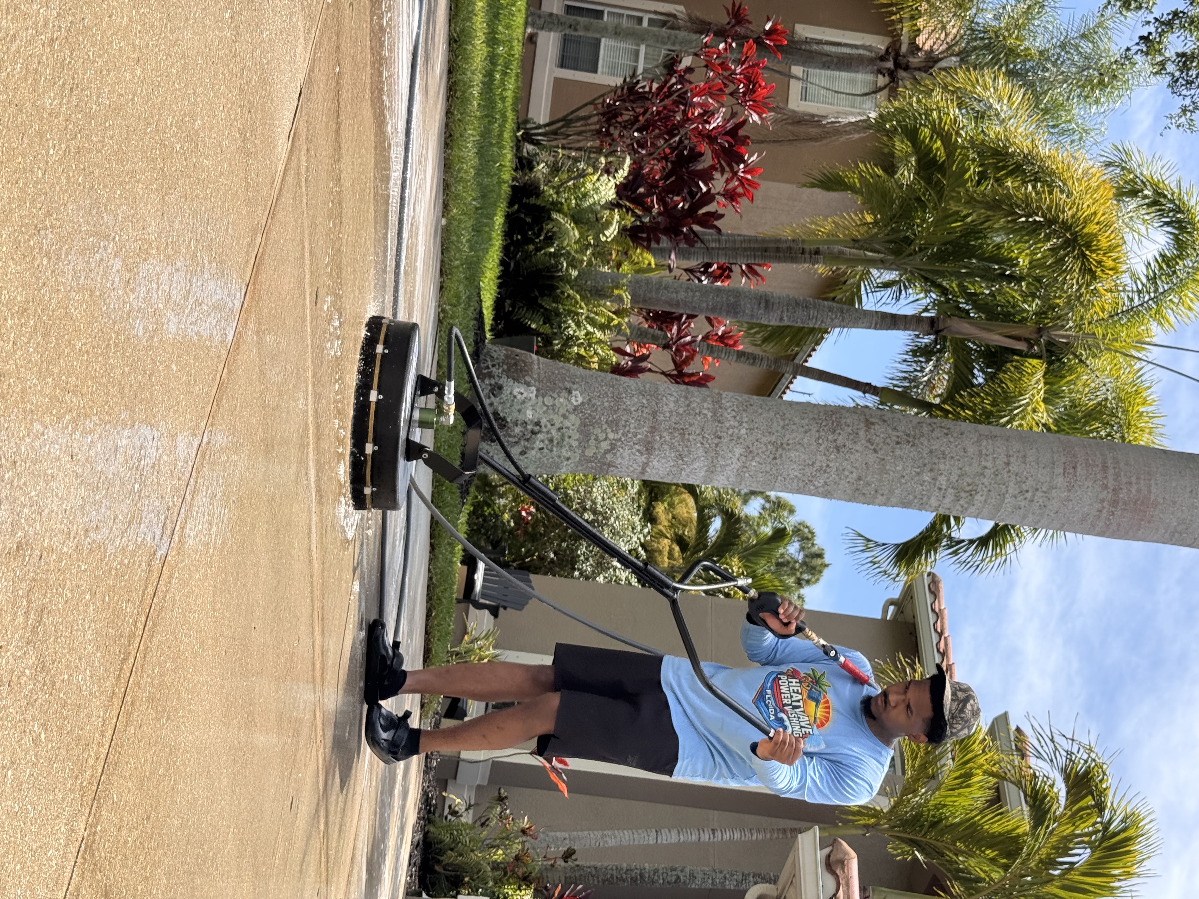 Heatwave technician surface cleaning a residential driveway.
